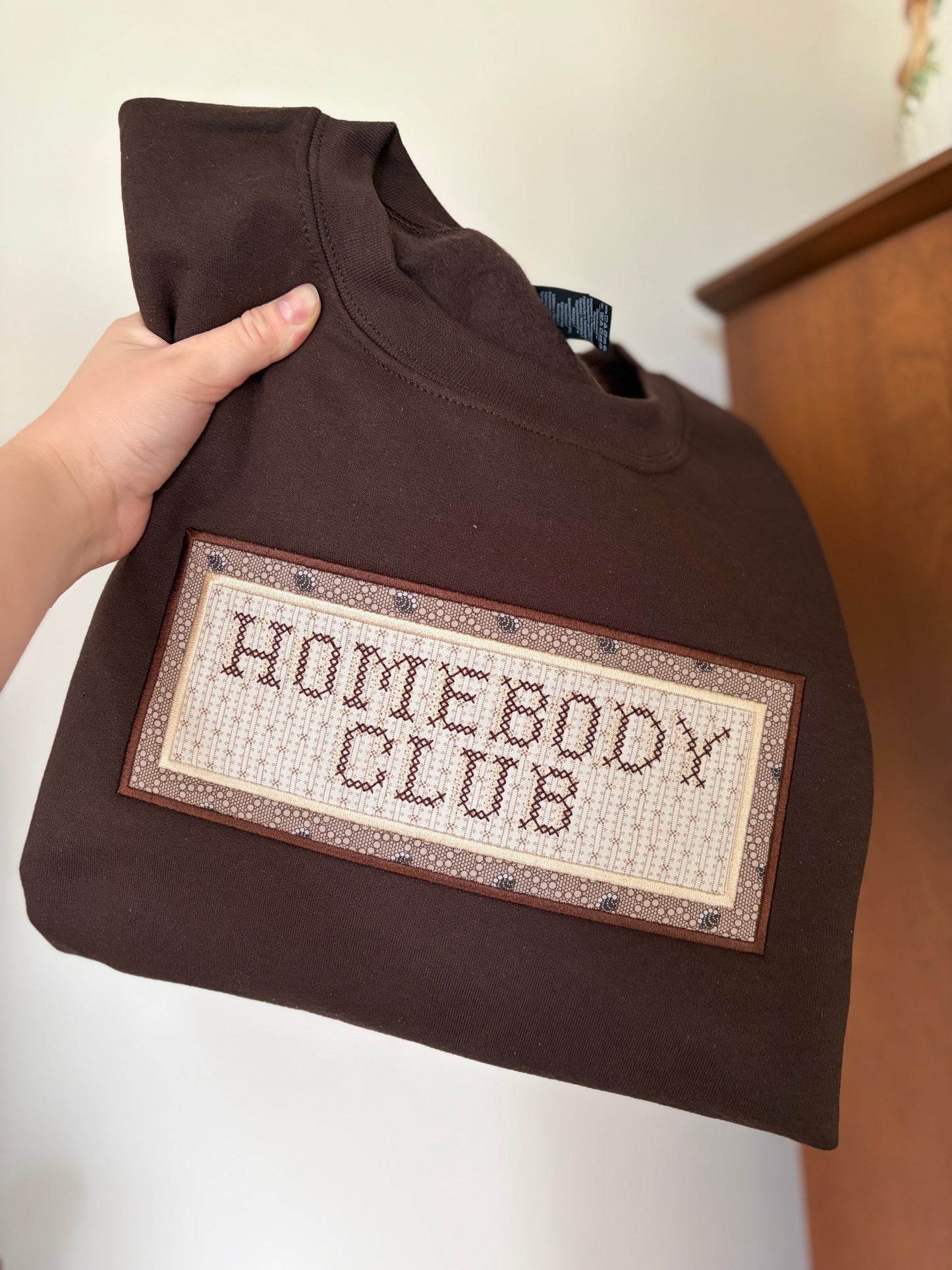 Homebody Club Cross Stitch Sweatshirt | Upcycled Patchwork Fabric Crewneck | Cozy Brown & Cream Embroidery